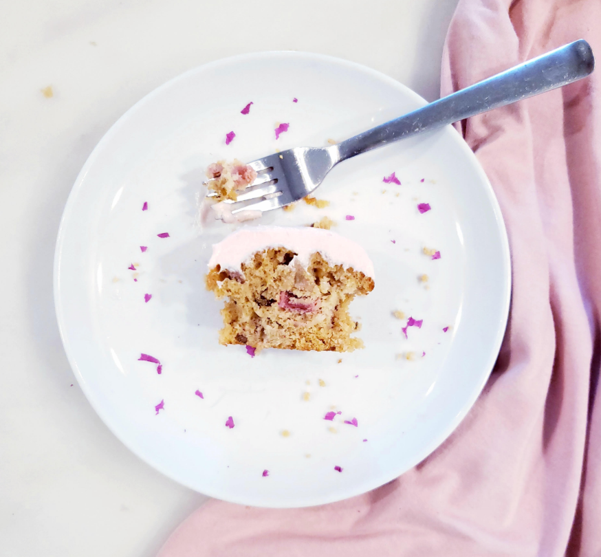 functional image rhubarb muffins on a plate crumbs cream cheese icing pink dessert snack brunch breakfast bite cut in half