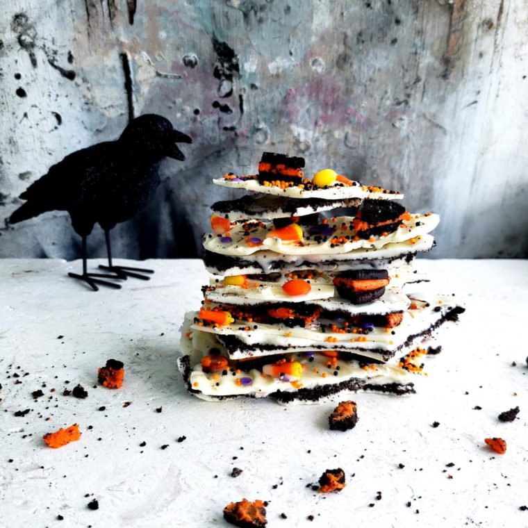functional image halloween white chocolate oreo bark side view with black crow stack of bark with broken halloween oreos with orange filling