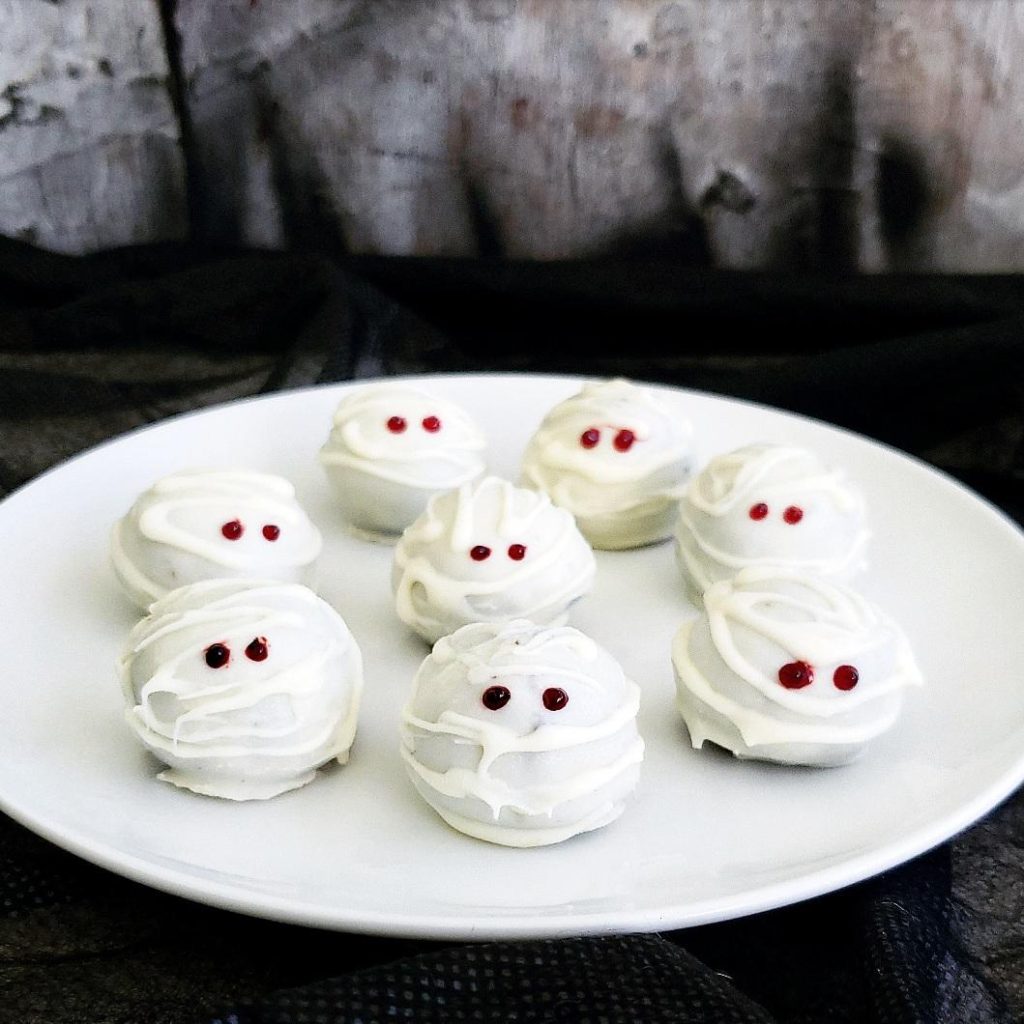 functional image oreo mummy truffles on a white plate side view red eyes