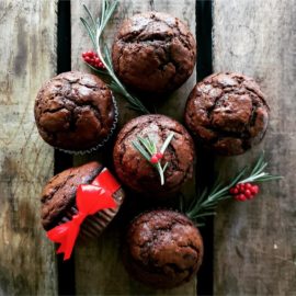 functional image dark chocolate gingerbread muffins top down photo with red bow holly berries and greenery