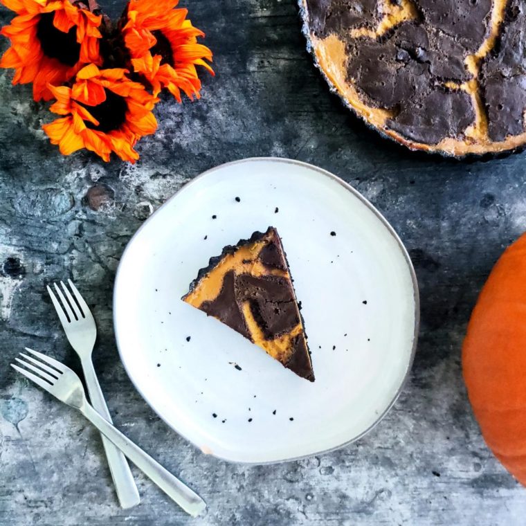 functional image double chocolate pumpkin pie with oreo crust with flowers and a pumpkin plated pie