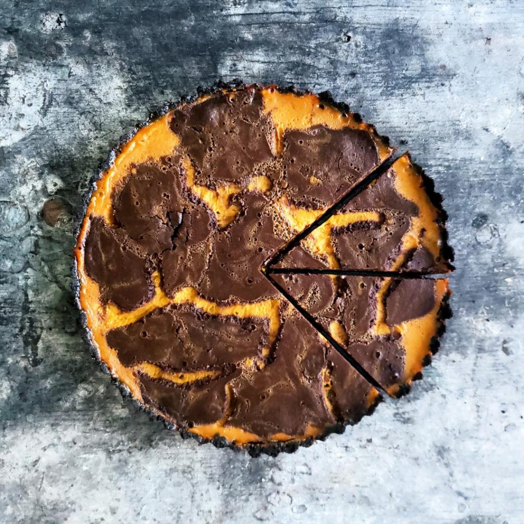 functional image double swirl chocolate pumpkin pie with oreo crust two slices cut top down photo