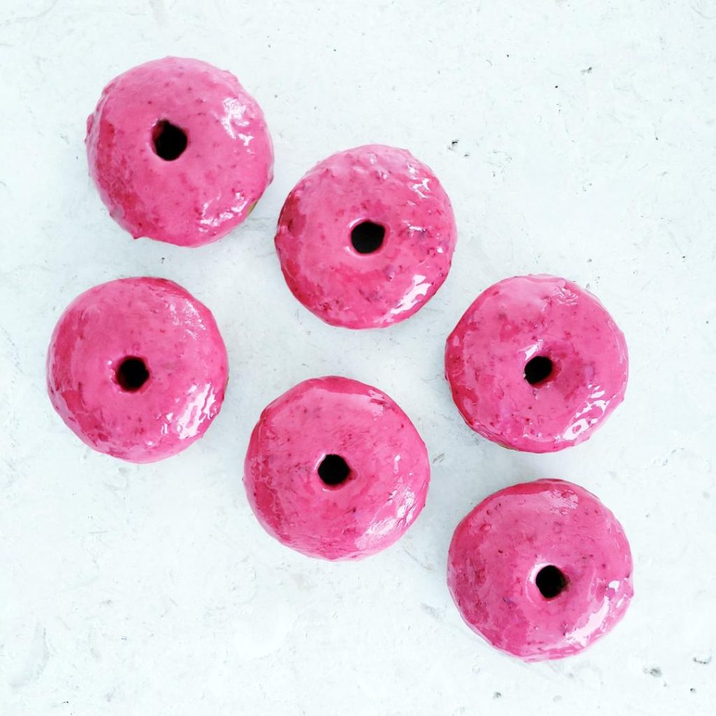 functional image baked spiced donuts with cranberry glaze 6 donuts on a white backgroun