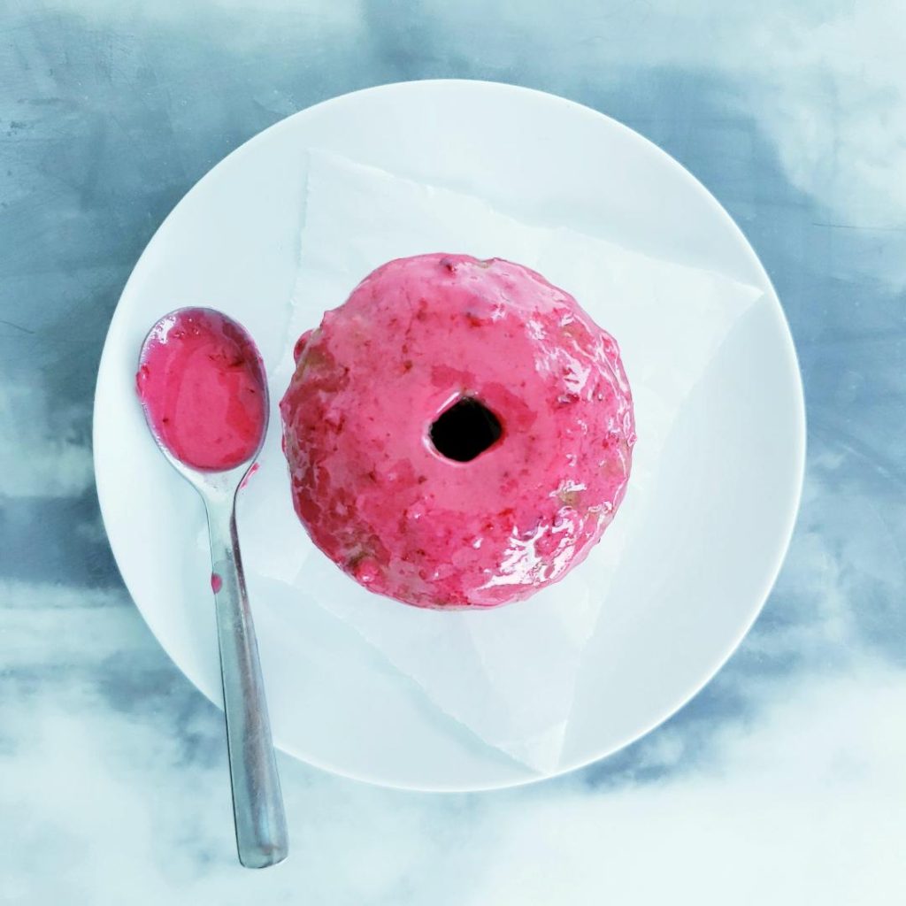 functional image baked spiced donuts with cranberry glaze one donut on a white plate