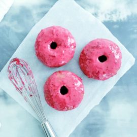 functional image baked spiced donuts with cranberry glaze top down photo 3 donuts and a whisk