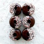 functional image chocolate donuts with peppermint schnapps glaze 6 donuts in 2 rows top down with crushed candy canes