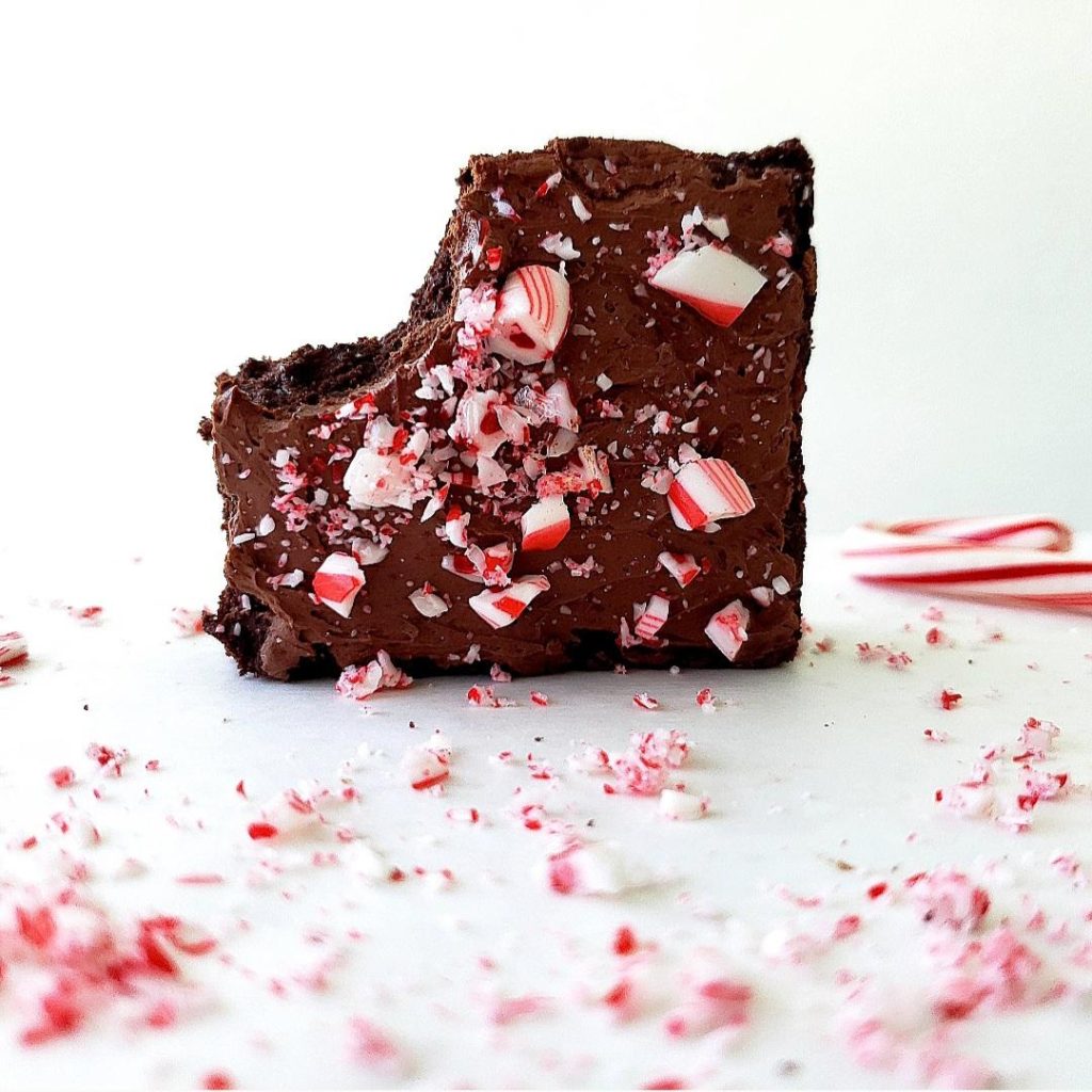 functional image peppermint brownies with whipped ganache and a bite missing from one brownie square