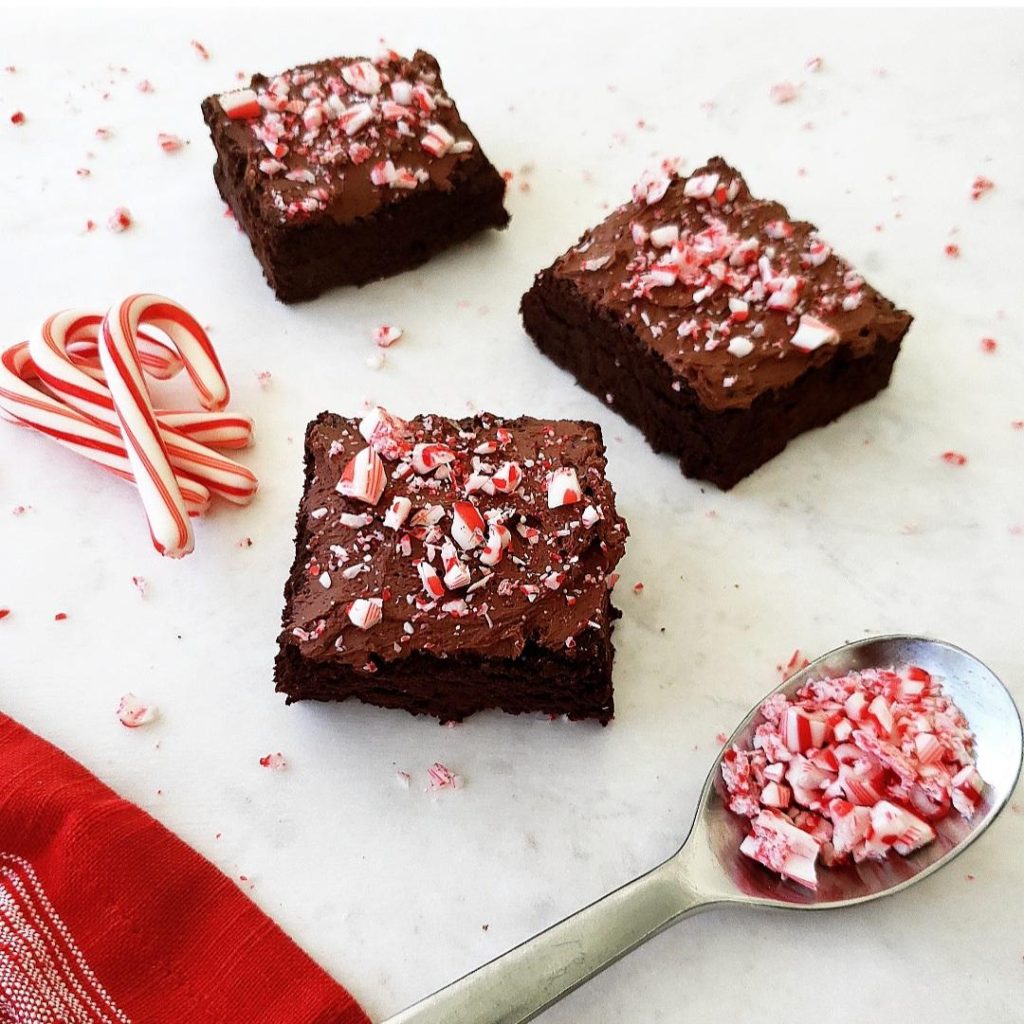 functional image peppermint brownies with whipped ganache three brownies scattered with mini candy canes