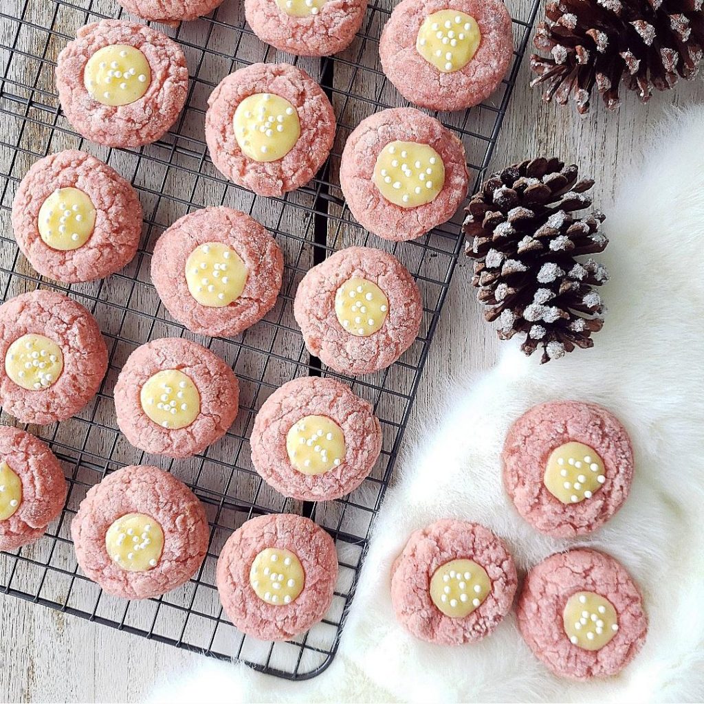 functional image pink velvet thumbprint cookies with cream cheese on a baking rack