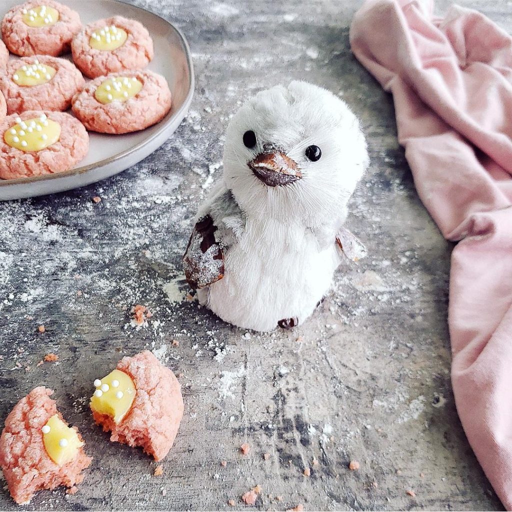 functional image pink velvet thumbprint cookies with cream cheese styled with with a baby penguin ornament