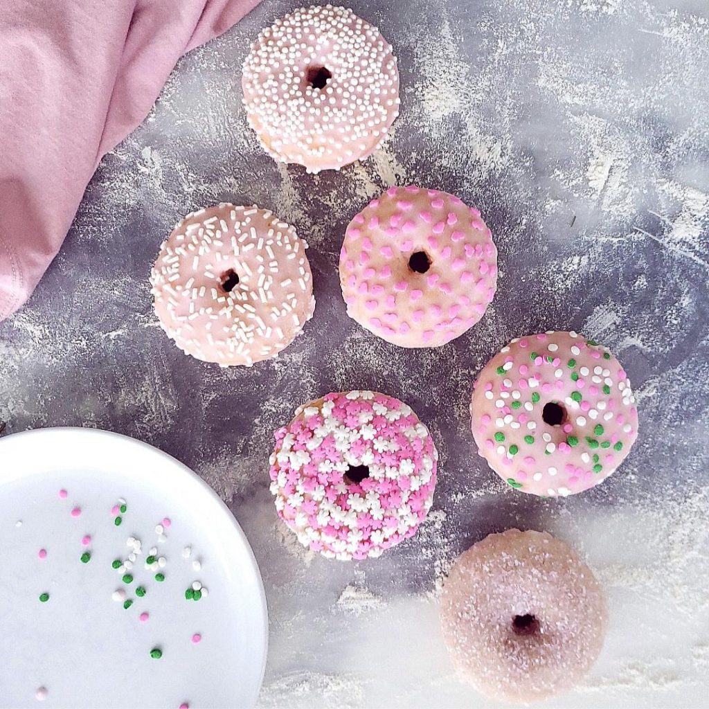 frosted sugar cookie donuts top down with sprinkles