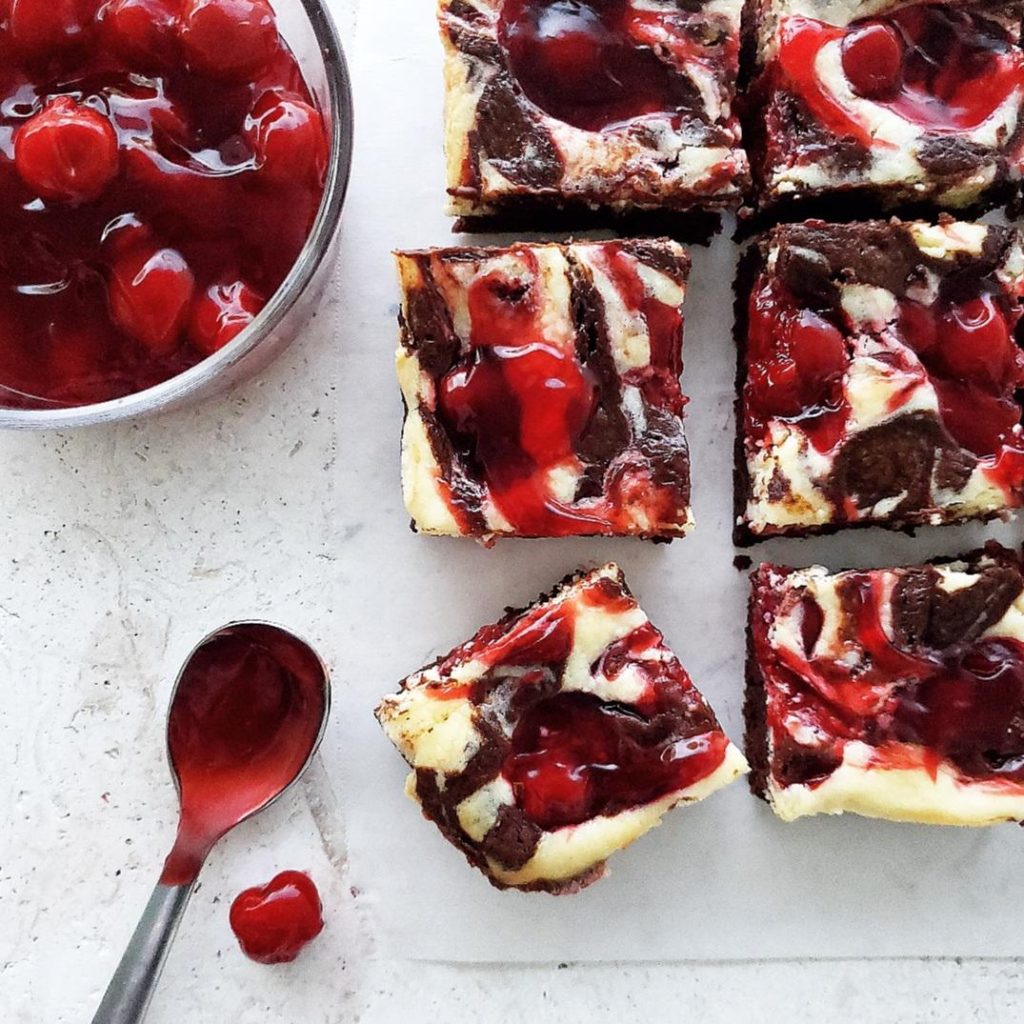 cherry cheesecake brownies recipe.  small batch cherry cheesecake brownies close up with bowl of cherries