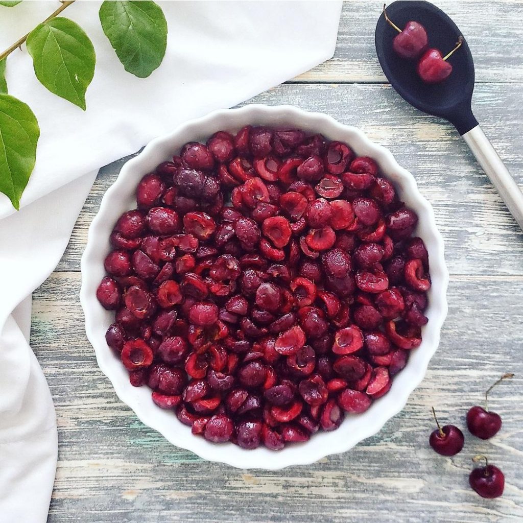 functional image cherry crisp with fresh cherries cherry filling in pie plate ready to bake