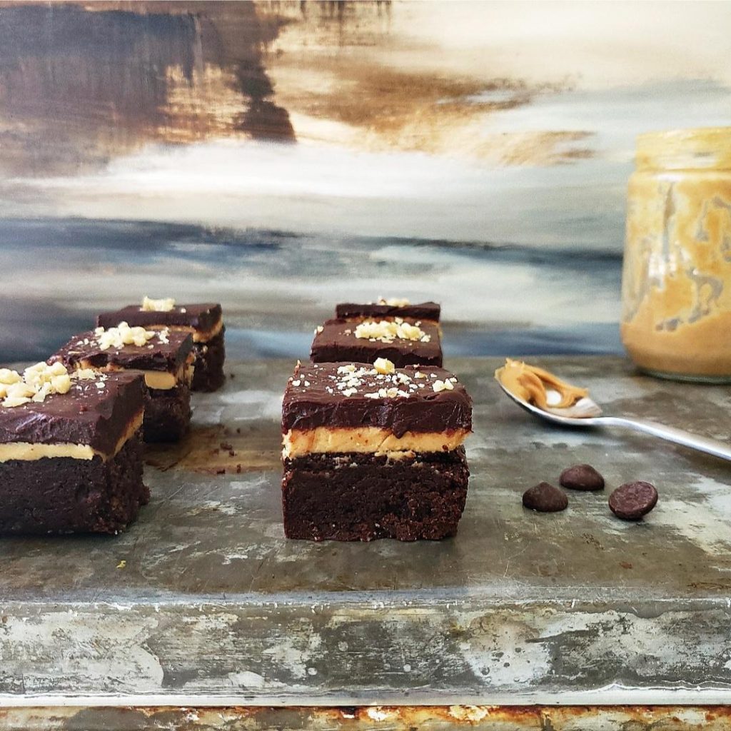 recipe for peanut butter brownies squares cut on a baking sheet