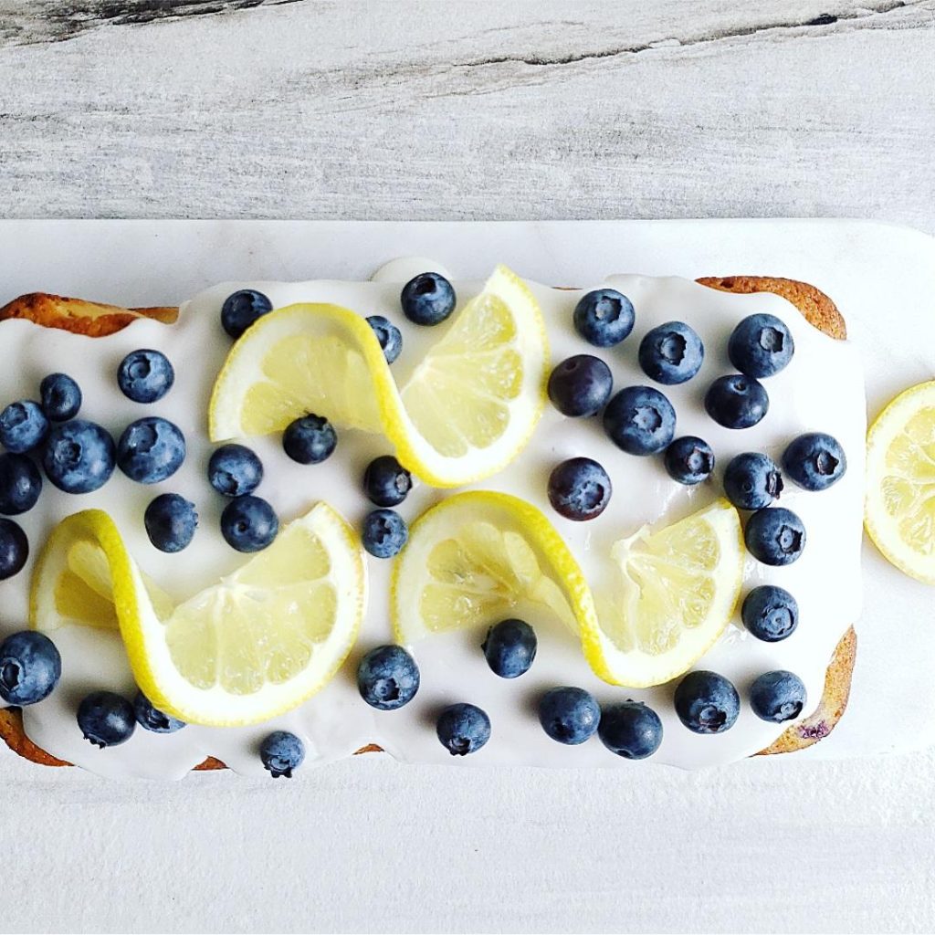 functional image blueberry lemon bread lemon blueberry bread quick bread icing fresh blueberries top down photo