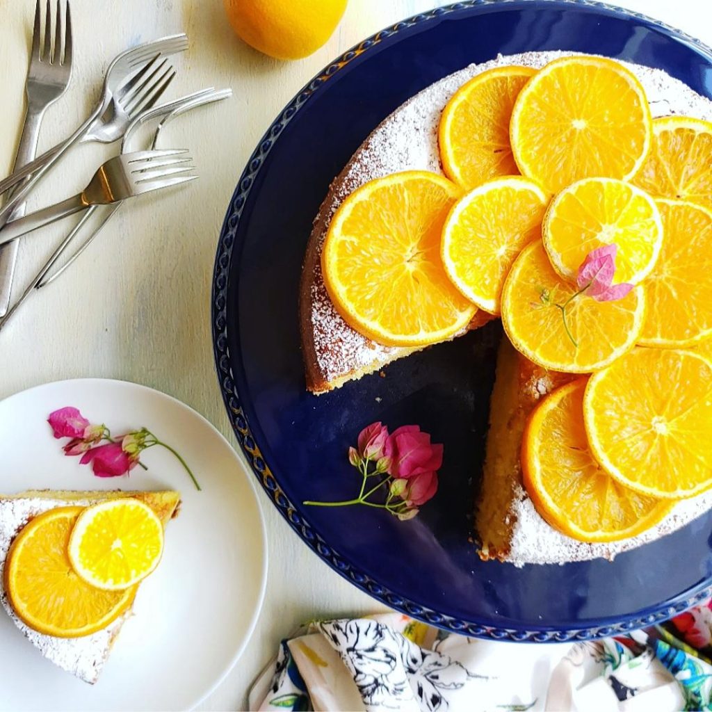 functional image cake with oranges slice on a plate with flowers