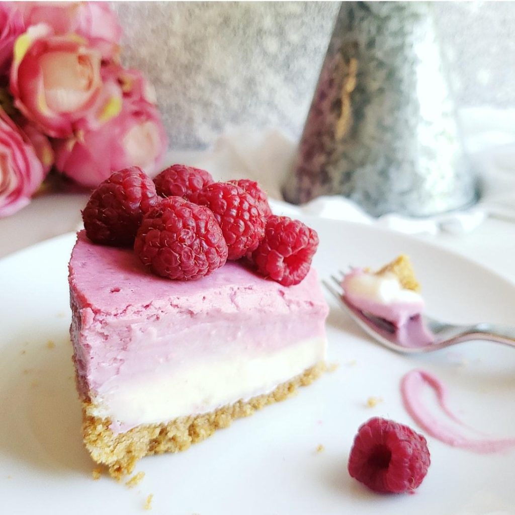 functional image raspberry cheesecake close up of a slice on a white plate with fresh raspberries