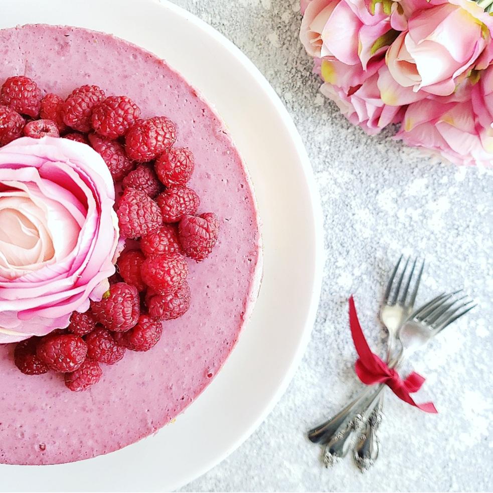 functional image raspberry cheesecake with fresh raspberries close up with a pink rose and forks