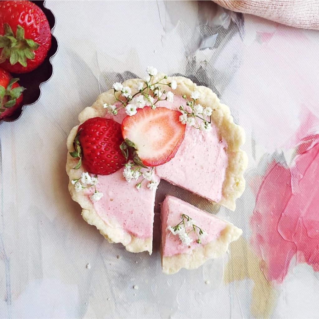 strawberry tartlets strawberry mini tart with a tiny slice cut out fresh strawberries and baby's breath flowers