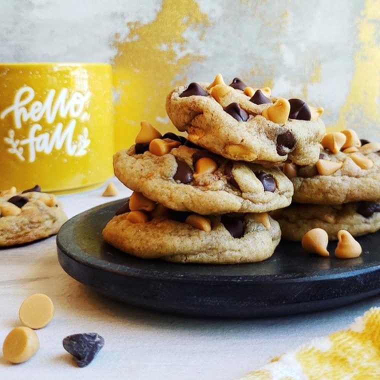 functional image chocolate chip butterscotch cookies on a black marble plate with a yellow hello fall coffee mug