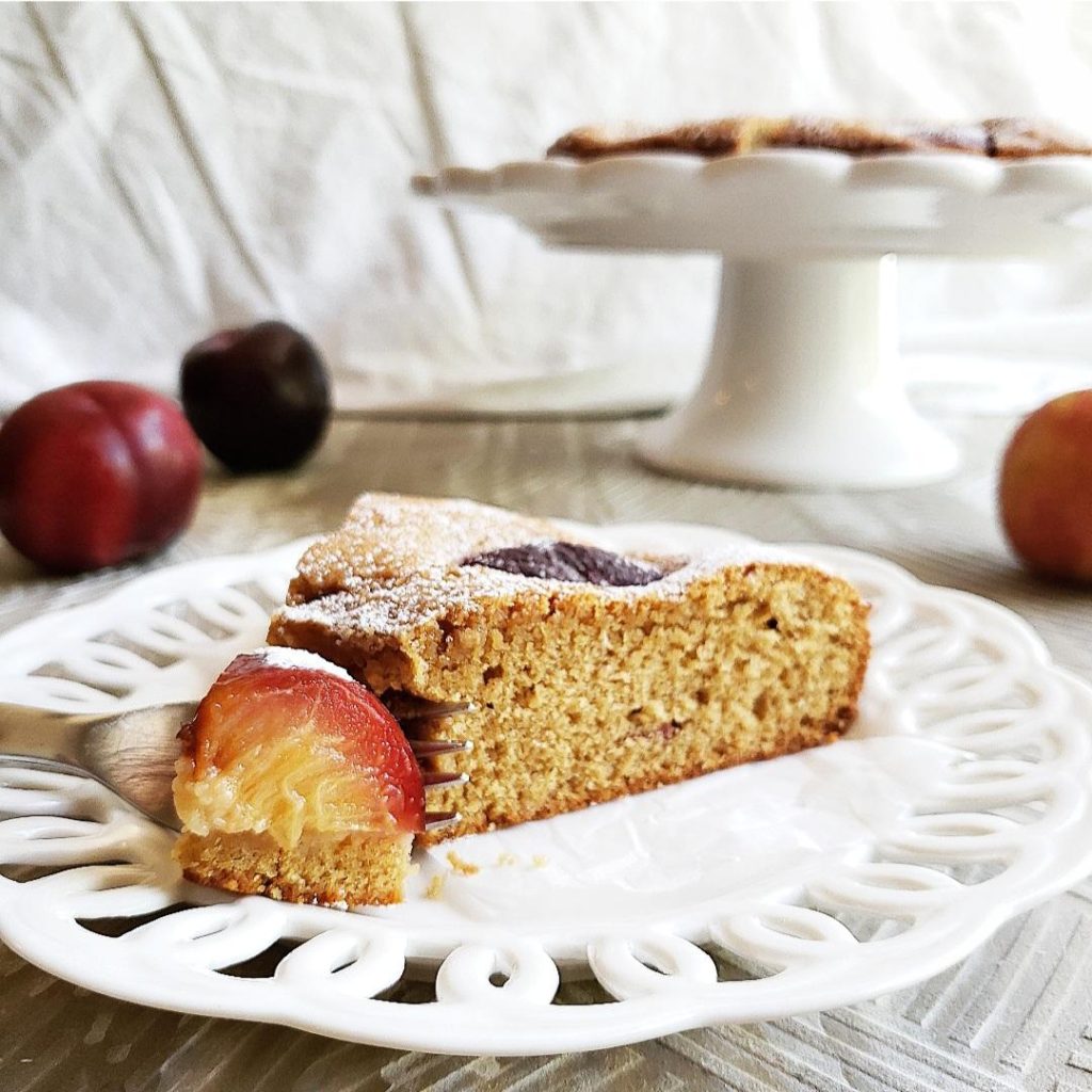 functional image plum cake plum torte cake with plums plated slice close up view with a fork 