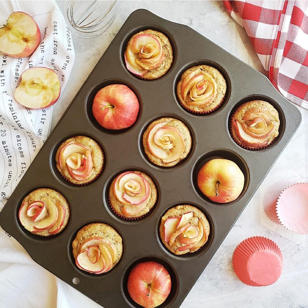 functional image apple cinnamon muffins in a muffin pan with apple roses and fresh apples