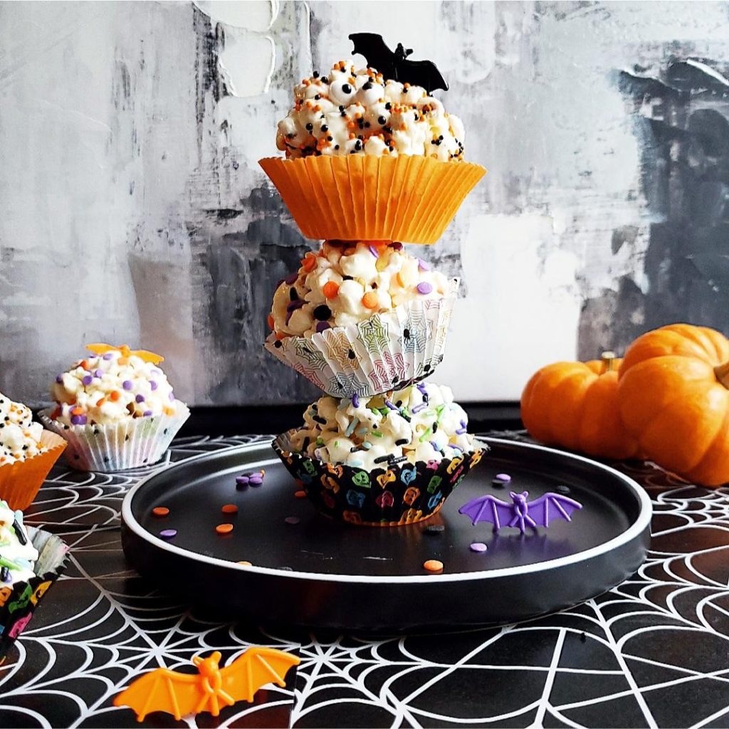 halloween popcorn balls stacked three high with mini pumpkins 