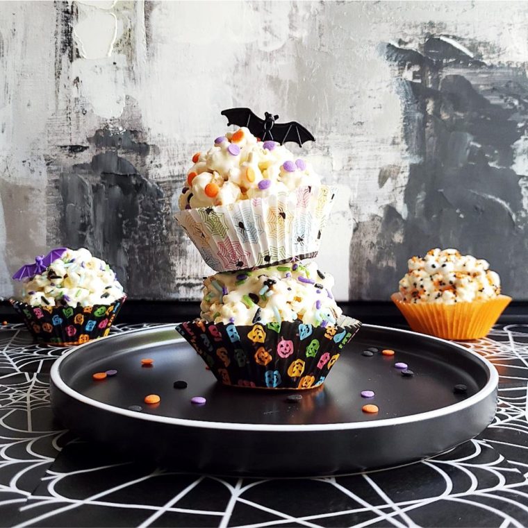 functional image halloween popcorn balls stacked two high with a black bat on top