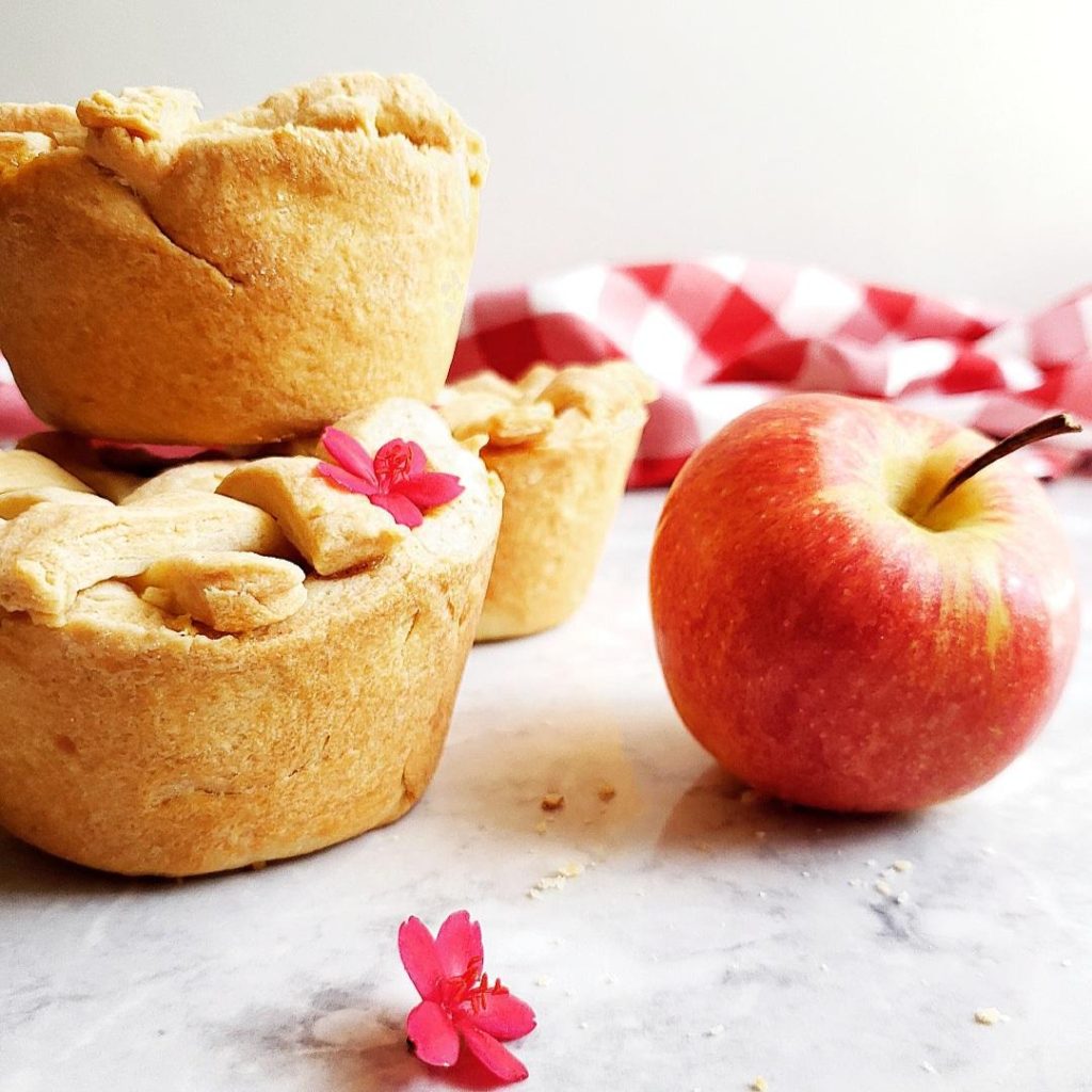 functional image jumbo muffin tin apple pies stacked with a fresh apple with a stem