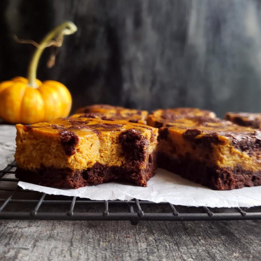 functional image small batch pumpkin cheesecake brownies close up of brownie with a bite taken 