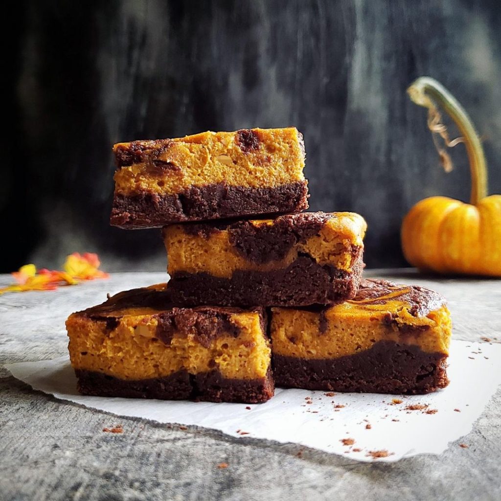 functional image pumpkin cheesecake brownies stacked like a pyramid