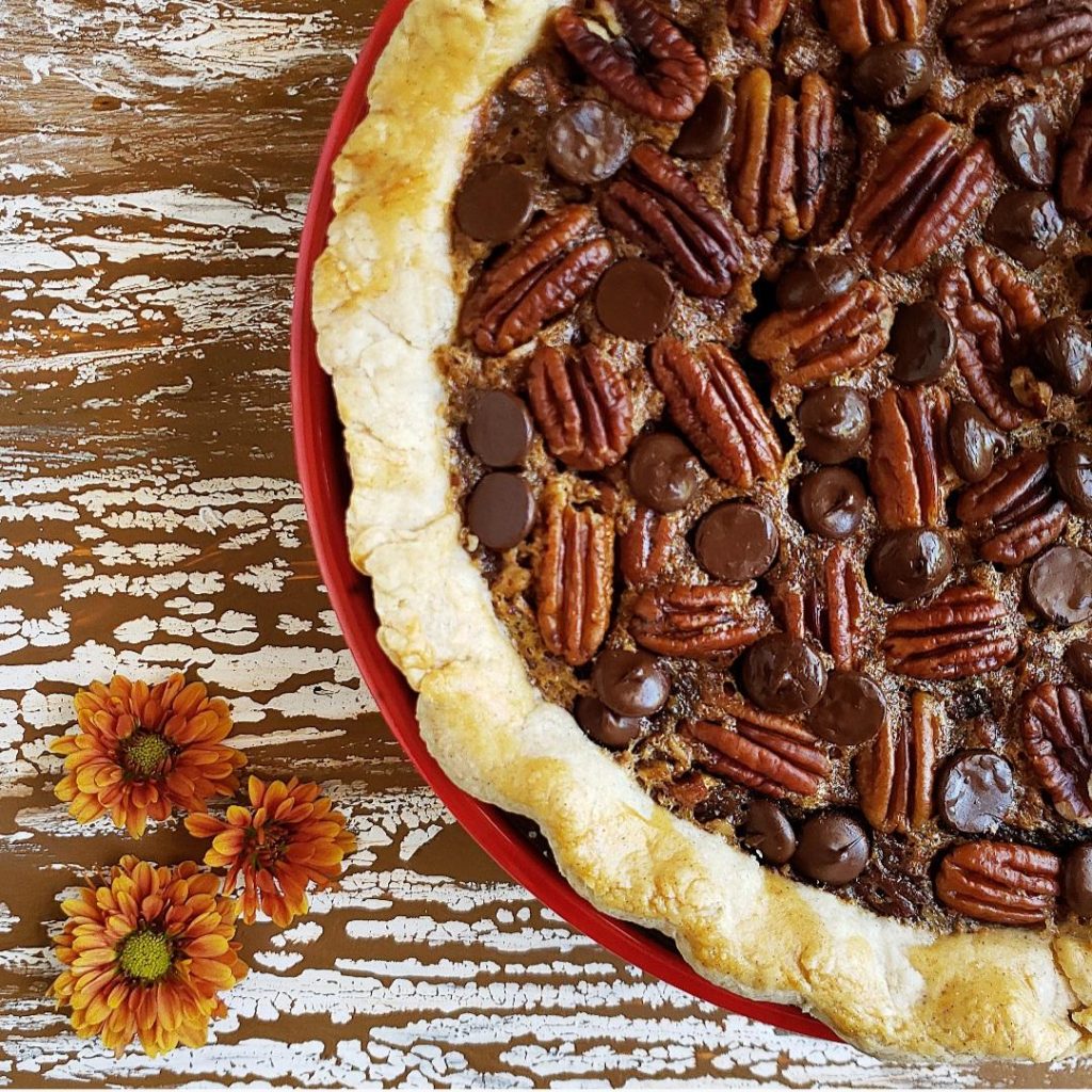 functional image chocolate chip pecan pie in a red pie dish