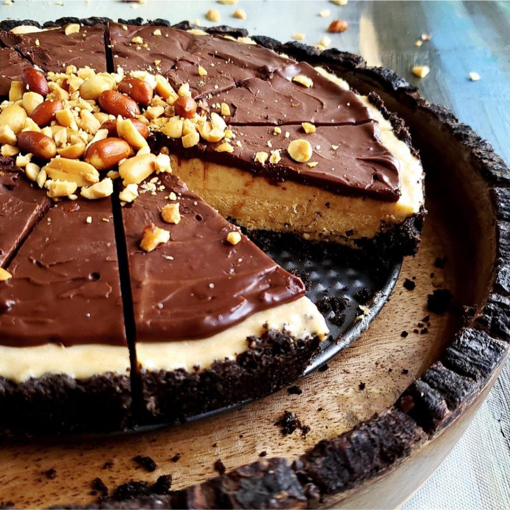 frozen peanut butter pie angle view of sliced pie with one piece missing zoomed in to see detail of pie layers and oreo crust