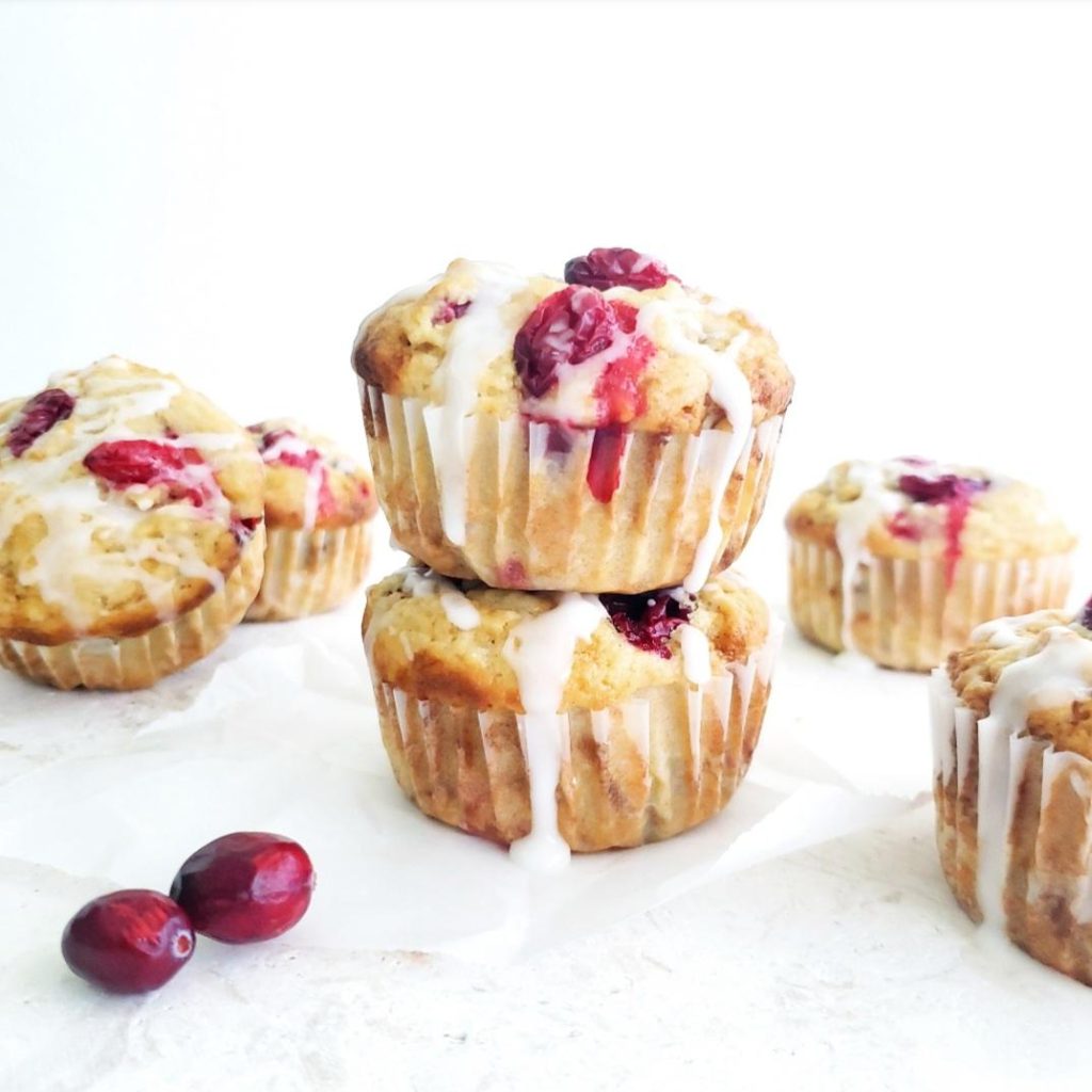 functional image cranberry muffins with walnuts and fresh cranberries and a vanilla glaze on a white background