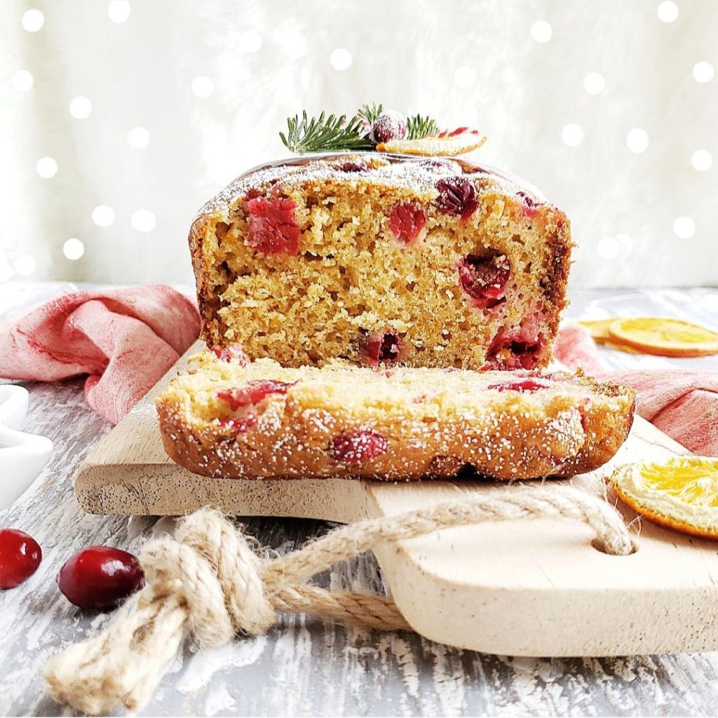 functional image cranberry orange bread side view sliced with close up up crumbs sliced oranges and baked cranberries