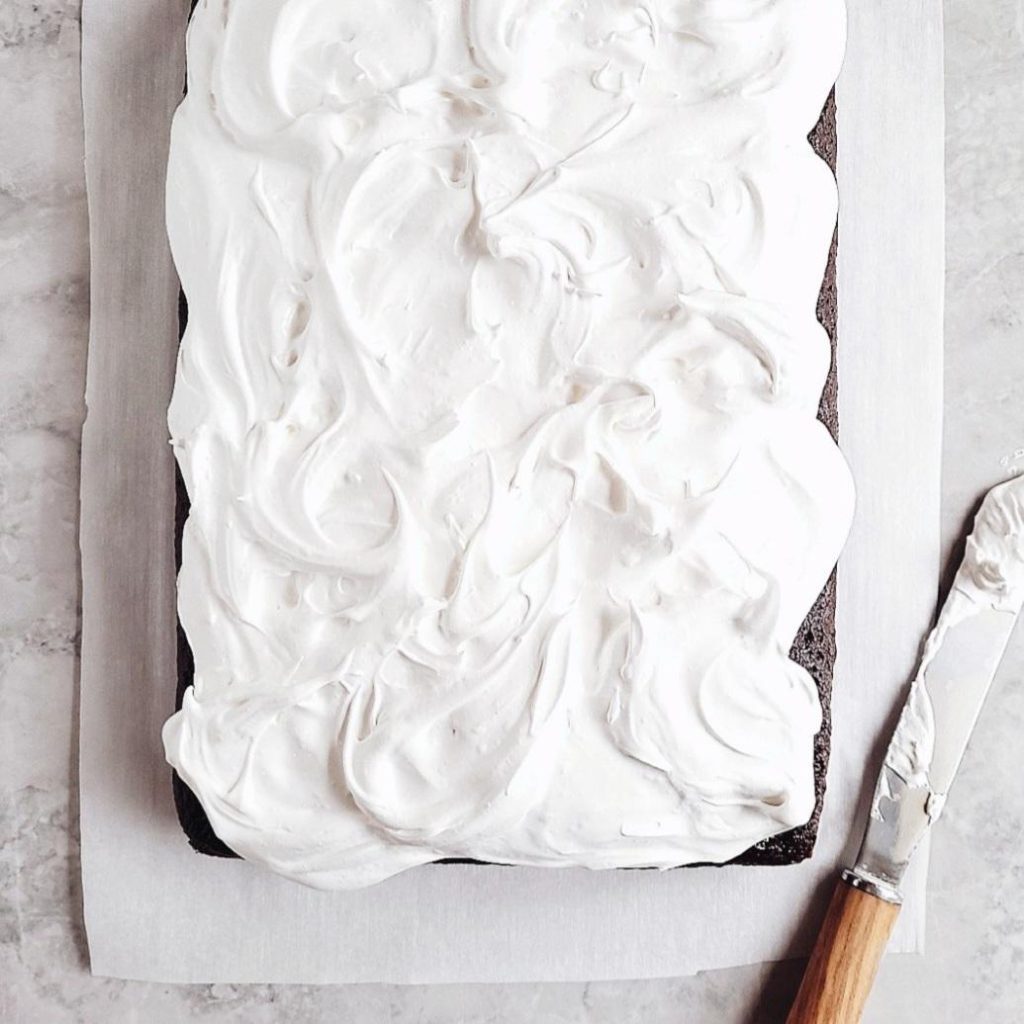 chocolate marshmallow sheet cake top down marshmallow meringue and an offset spatula on gray marble