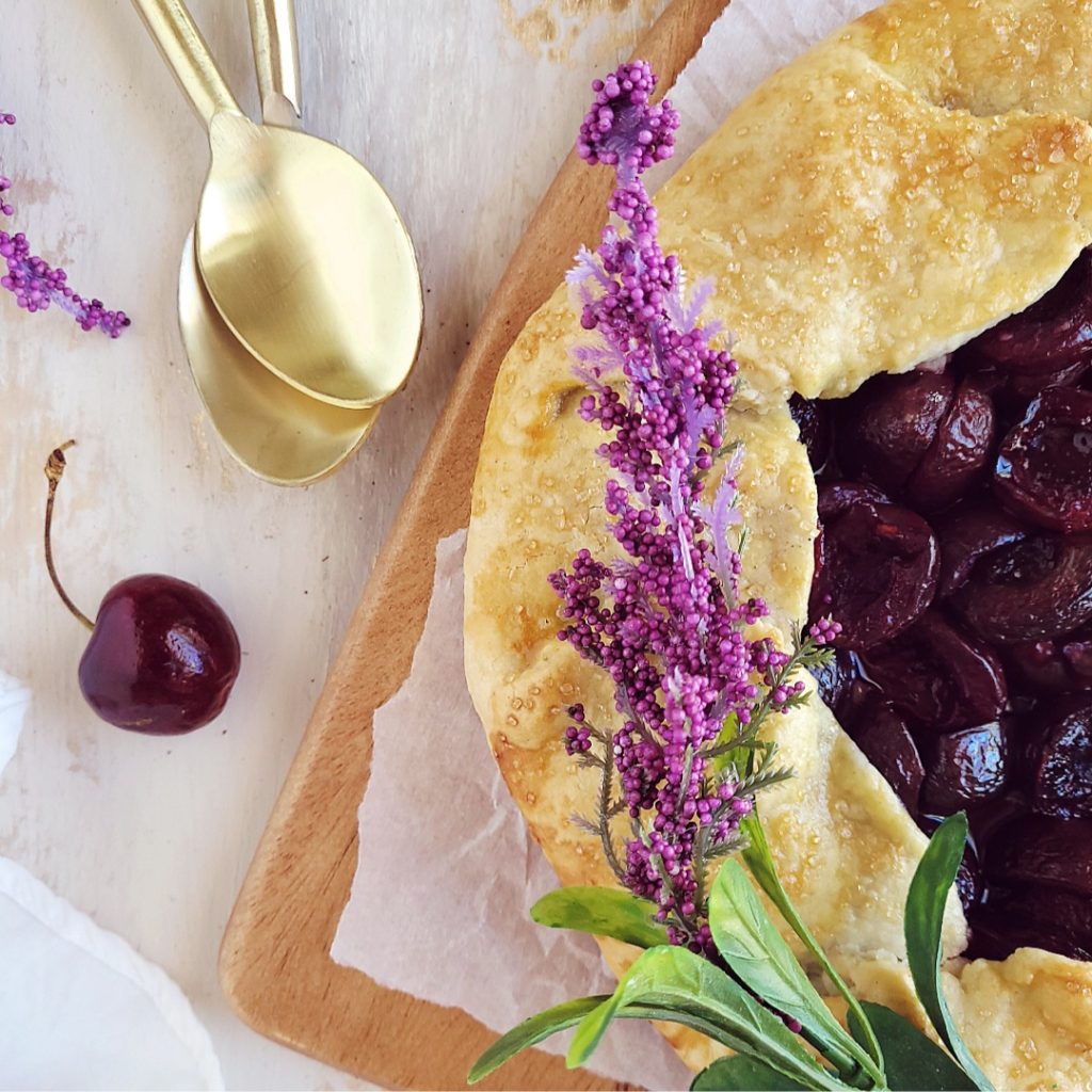 functional image cherry tart top down rustic crust with lavender and two gold spoons