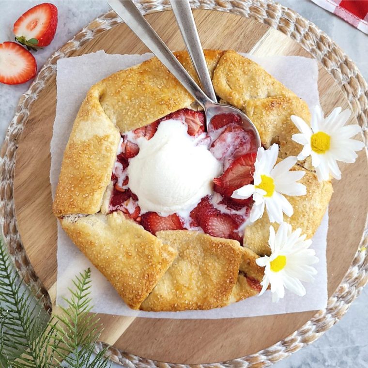 functional image strawberry galette top down two spoons in it with a melting scoop of vanilla ice cream