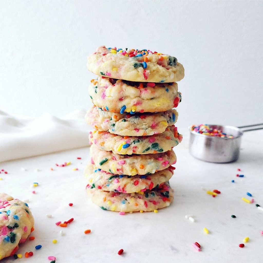 functional image funfetti cookies sugar cookies cookies with sprinkles stacked 7 high on a white background