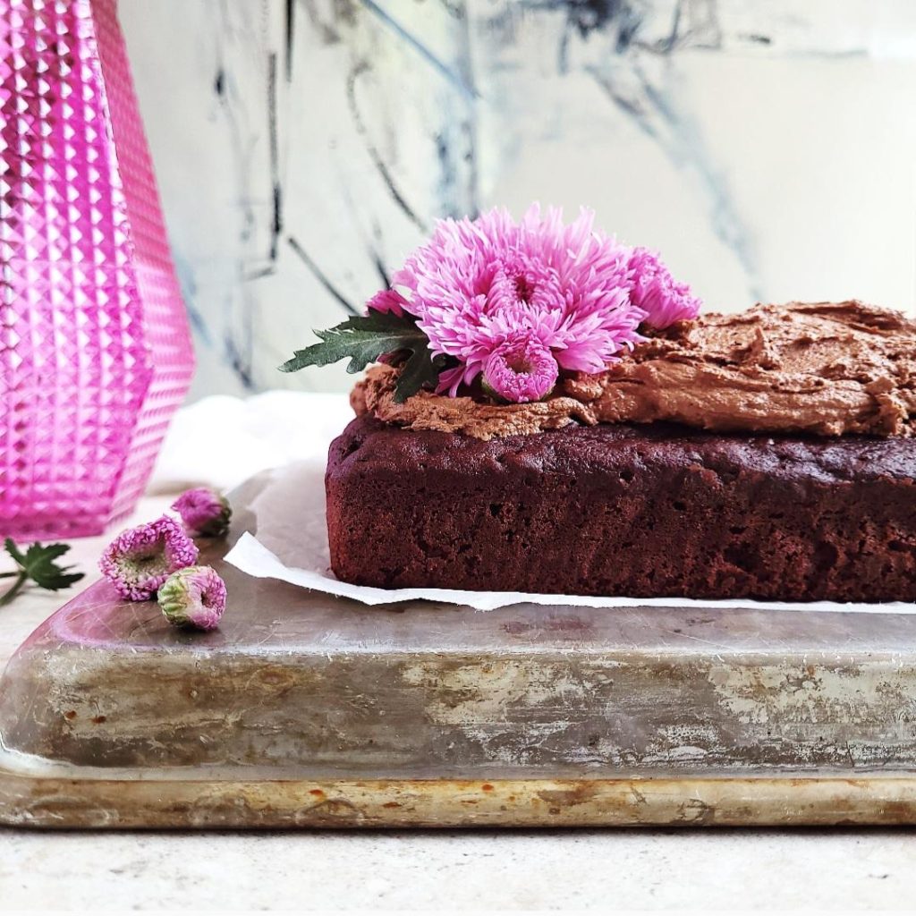 functional image nutella cake with nutella buttercream sheet cake side view with purple flowers and a purple vase