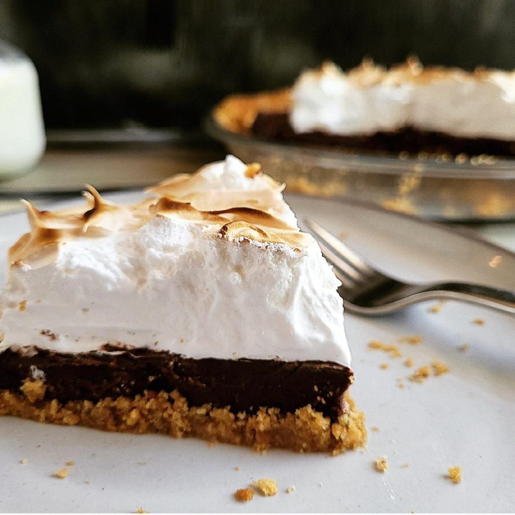functional image smores pie slice on a plate with graham cracker crust chocolate pie and toasted marshmallow topping side view