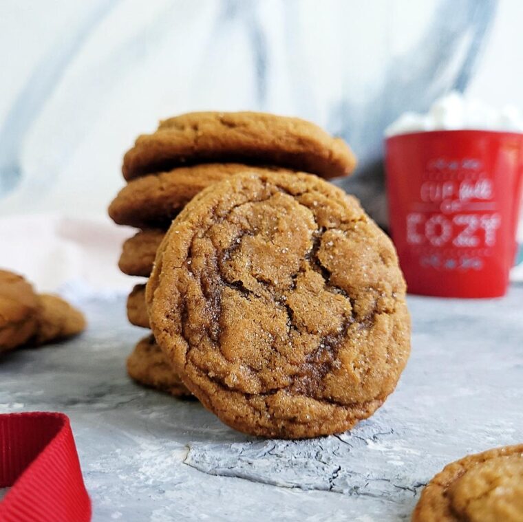 functional image gingerdoodle cookies ginger cookies cookie stack with a red cup of hot cocoa in the background on an abstract gray surface