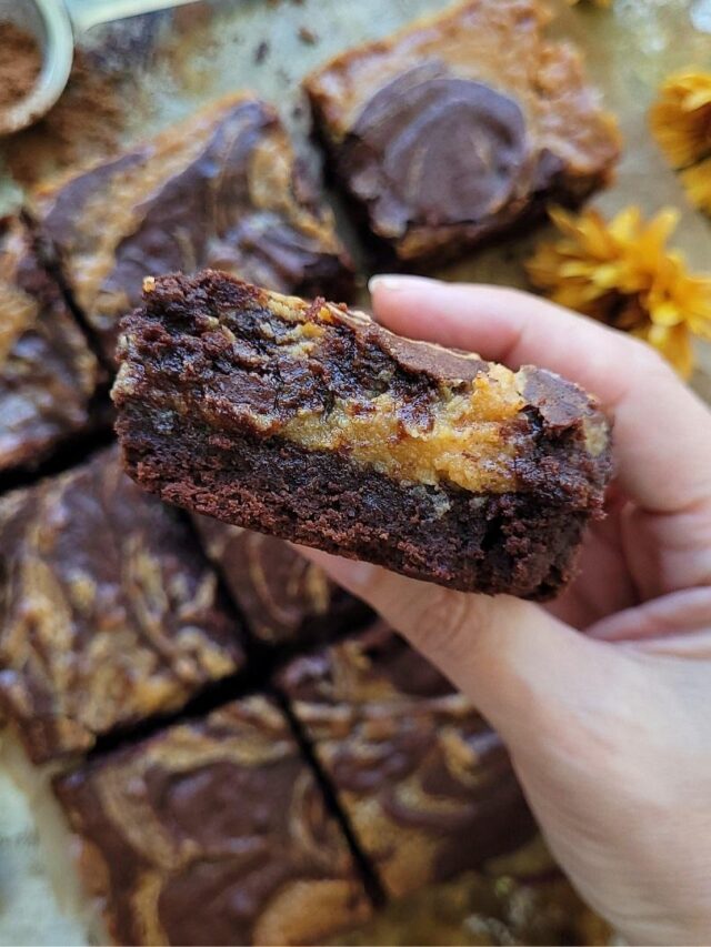 cropped-caramel-brownies-hand-holding-brownie-slice.jpg