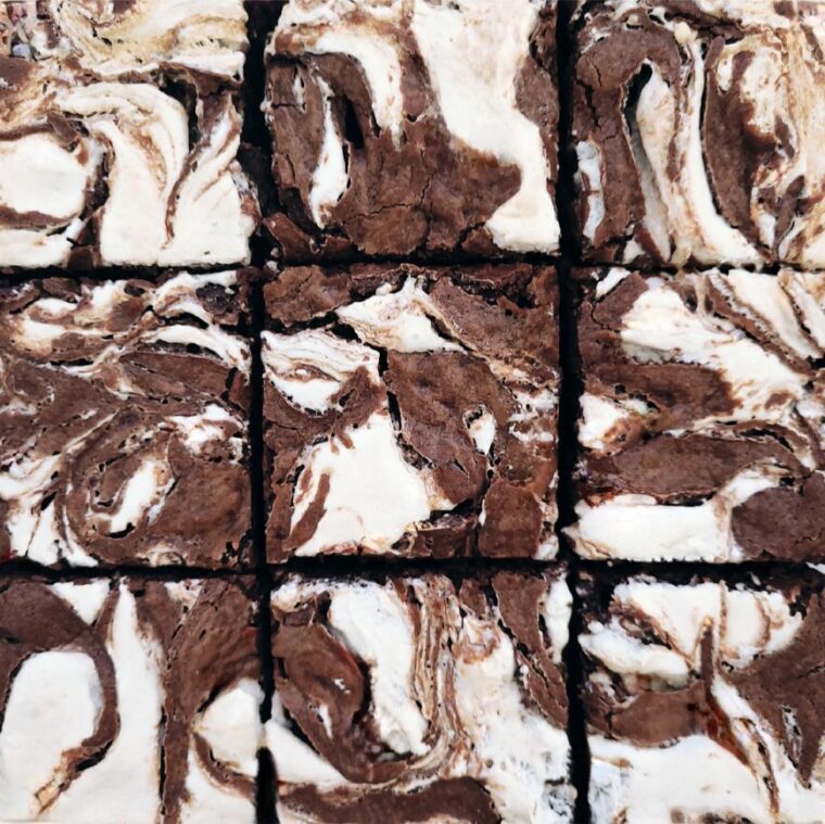 swirled marshmallow brownies. top down, close up view of brownies cut into 9 squares.